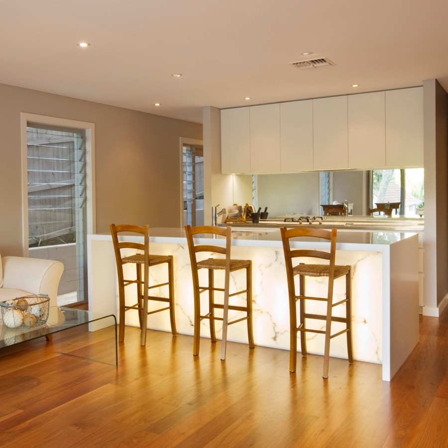 Example of a mid-sized minimalist galley kitchen design in Sydney with an island