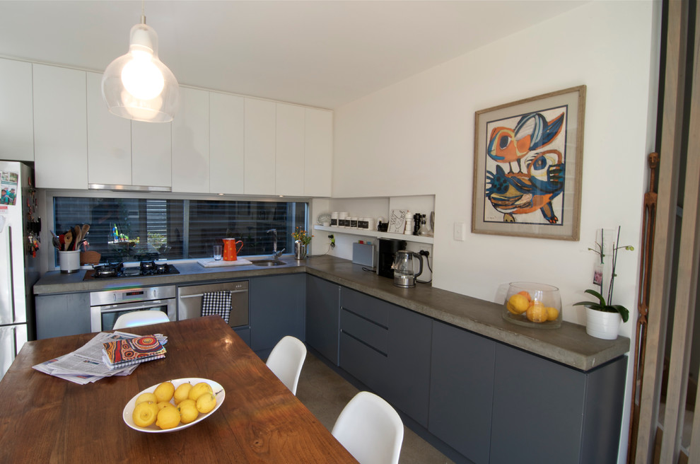 Example of an eclectic kitchen design in Adelaide with concrete countertops