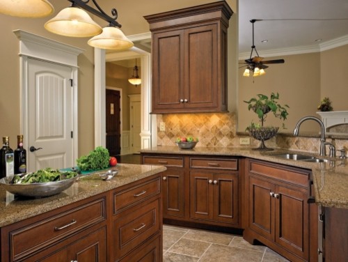 Eat-in kitchen - traditional u-shaped eat-in kitchen idea in Philadelphia with an undermount sink, medium tone wood cabinets, granite countertops, multicolored backsplash, stone tile backsplash and stainless steel appliances