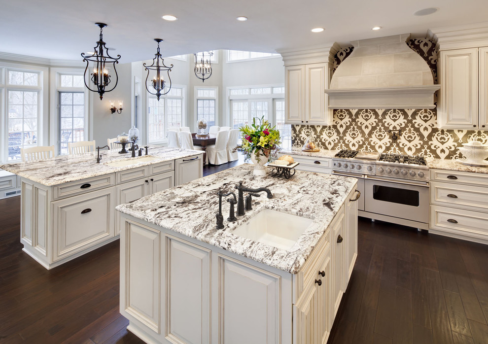 Eat-in kitchen - traditional eat-in kitchen idea in Chicago with white appliances, granite countertops, raised-panel cabinets and white cabinets