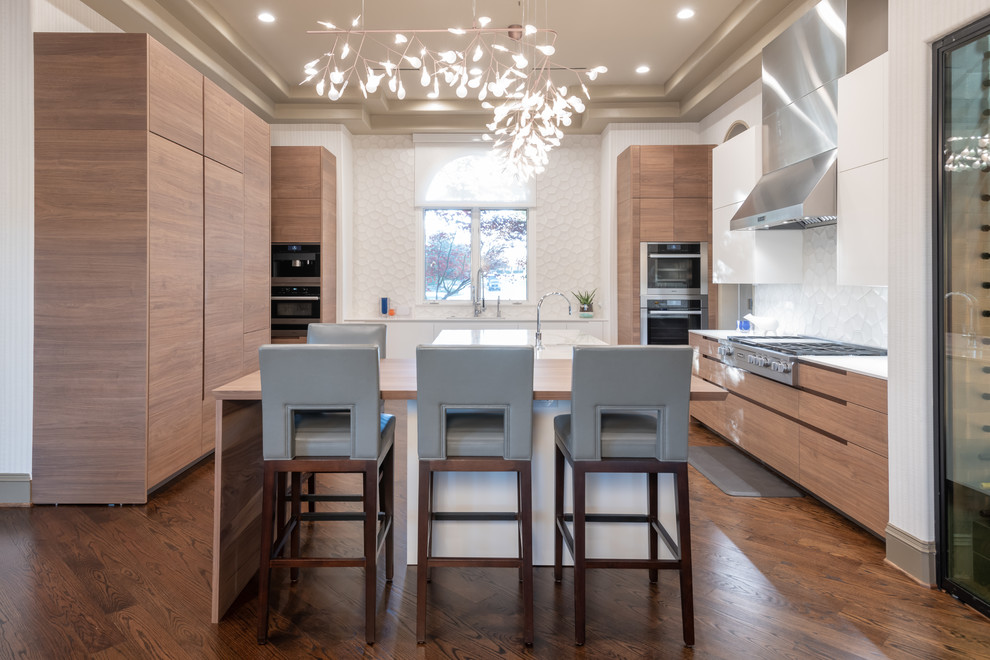 Inspiration for a large contemporary brown floor and dark wood floor kitchen remodel in Dallas with flat-panel cabinets, light wood cabinets, quartz countertops, white backsplash, cement tile backsplash, paneled appliances, an island and white countertops