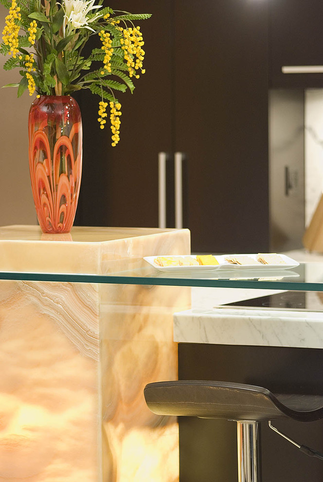 Example of a trendy kitchen design in Louisville with glass countertops