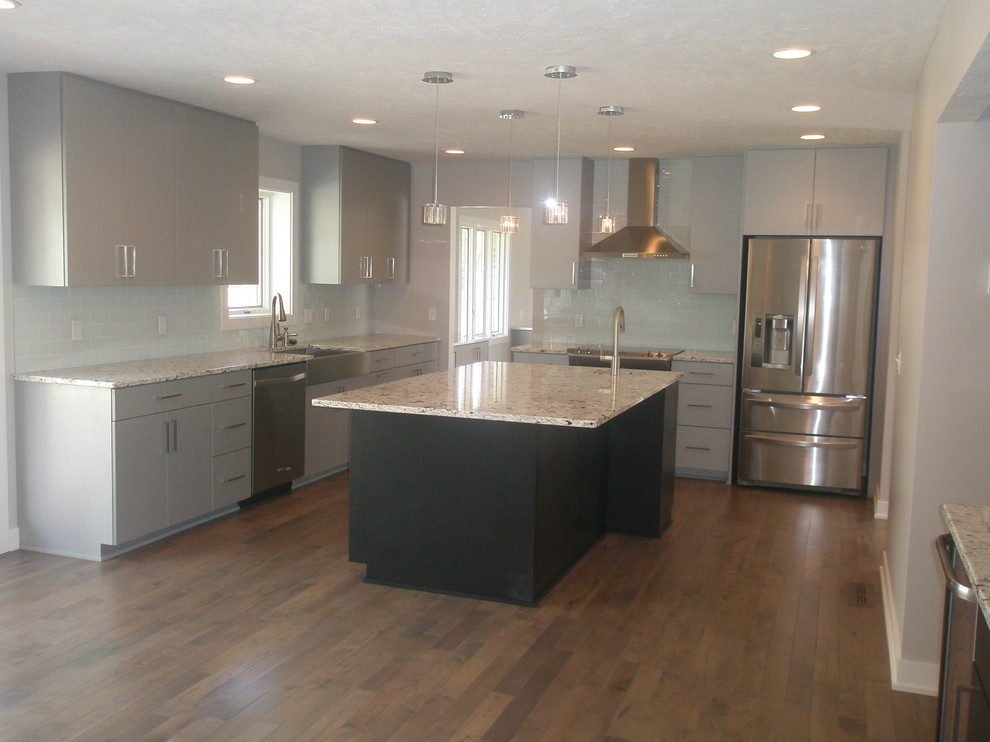Example of a small minimalist single-wall medium tone wood floor eat-in kitchen design in Other with an undermount sink, flat-panel cabinets, gray cabinets, granite countertops, glass tile backsplash, stainless steel appliances, white backsplash and no island