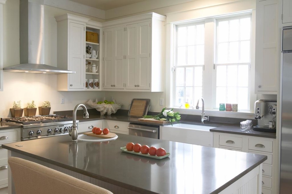 Inspiration for a timeless u-shaped eat-in kitchen remodel in New Orleans with a farmhouse sink, recessed-panel cabinets, white cabinets, quartzite countertops, white backsplash and stainless steel appliances
