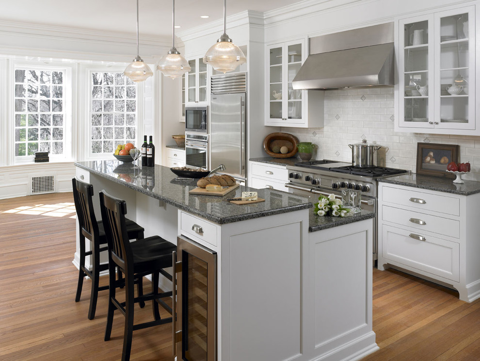 Photo of a traditional kitchen in Philadelphia with glass-front cabinets and stainless steel appliances.