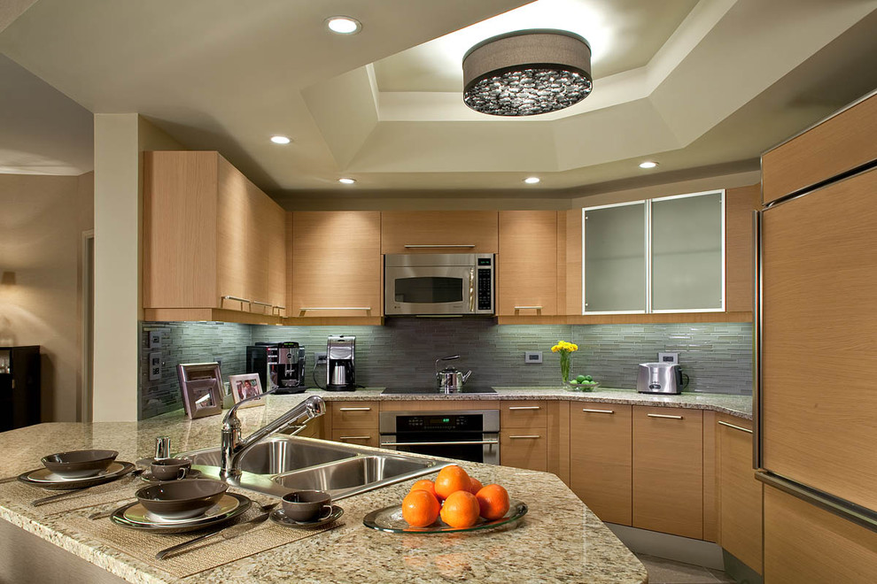 Exempel på ett modernt kök, med integrerade vitvaror, granitbänkskiva, en nedsänkt diskho, släta luckor, skåp i mellenmörkt trä, blått stänkskydd och stänkskydd i stickkakel