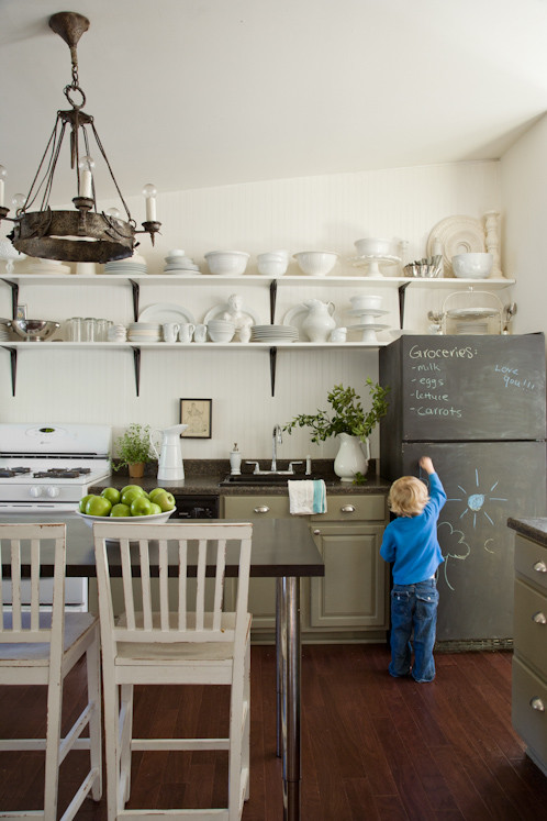 Design ideas for an eclectic single-wall enclosed kitchen in DC Metro with open cabinets, green cabinets and white appliances.