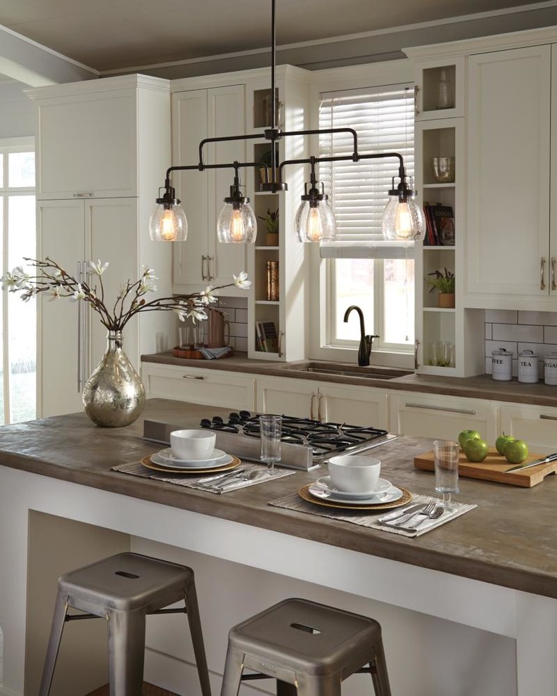 Example of a mid-sized transitional l-shaped kitchen design in Detroit with an undermount sink, beaded inset cabinets, white cabinets, wood countertops, white backsplash, subway tile backsplash, paneled appliances and an island