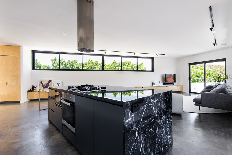 Inspiration for a small modern galley concrete floor eat-in kitchen remodel in Perth with a single-bowl sink, louvered cabinets, black cabinets, marble countertops, white backsplash, ceramic backsplash, stainless steel appliances and two islands