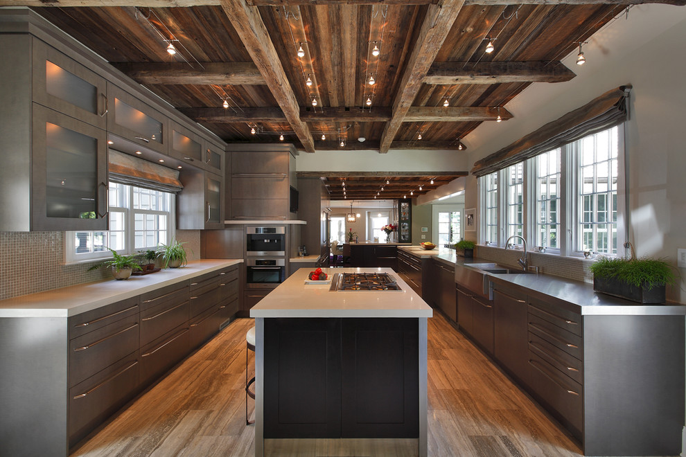 Inspiration for a large contemporary u-shaped medium tone wood floor eat-in kitchen remodel in New York with a farmhouse sink, flat-panel cabinets, gray cabinets, gray backsplash, stainless steel appliances, concrete countertops, mosaic tile backsplash and an island