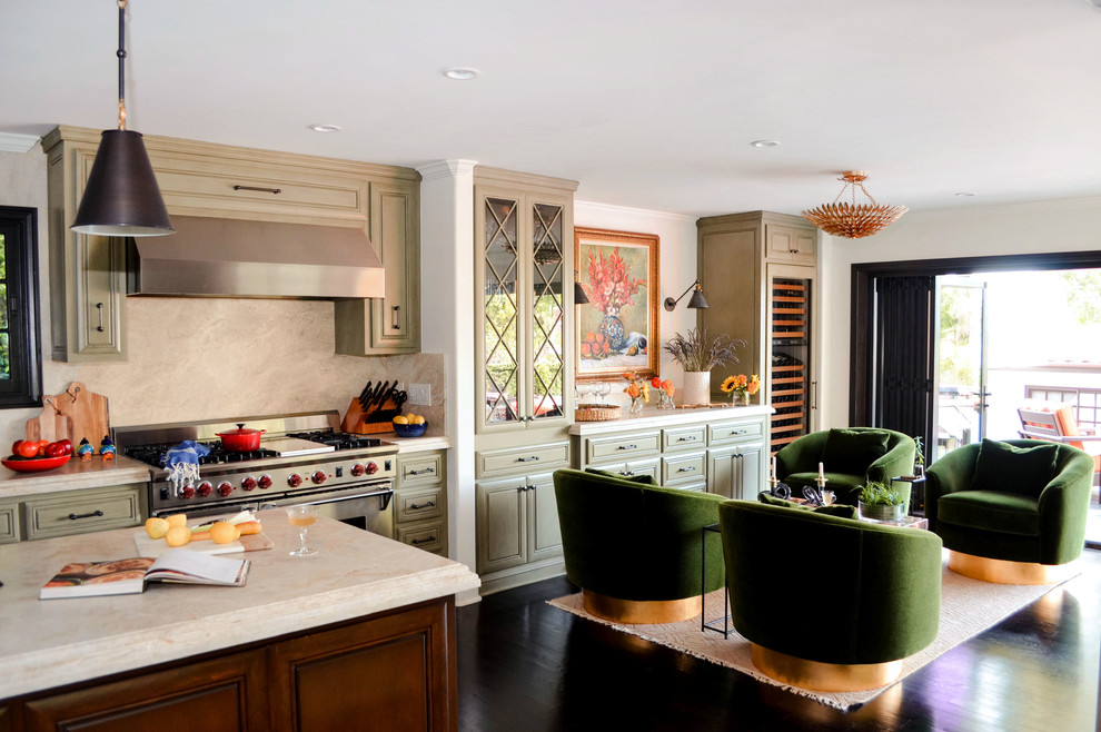 Open concept kitchen - large mediterranean l-shaped dark wood floor and brown floor open concept kitchen idea in Los Angeles with an undermount sink, raised-panel cabinets, green cabinets, quartzite countertops, beige backsplash, stone slab backsplash, paneled appliances, an island and beige countertops