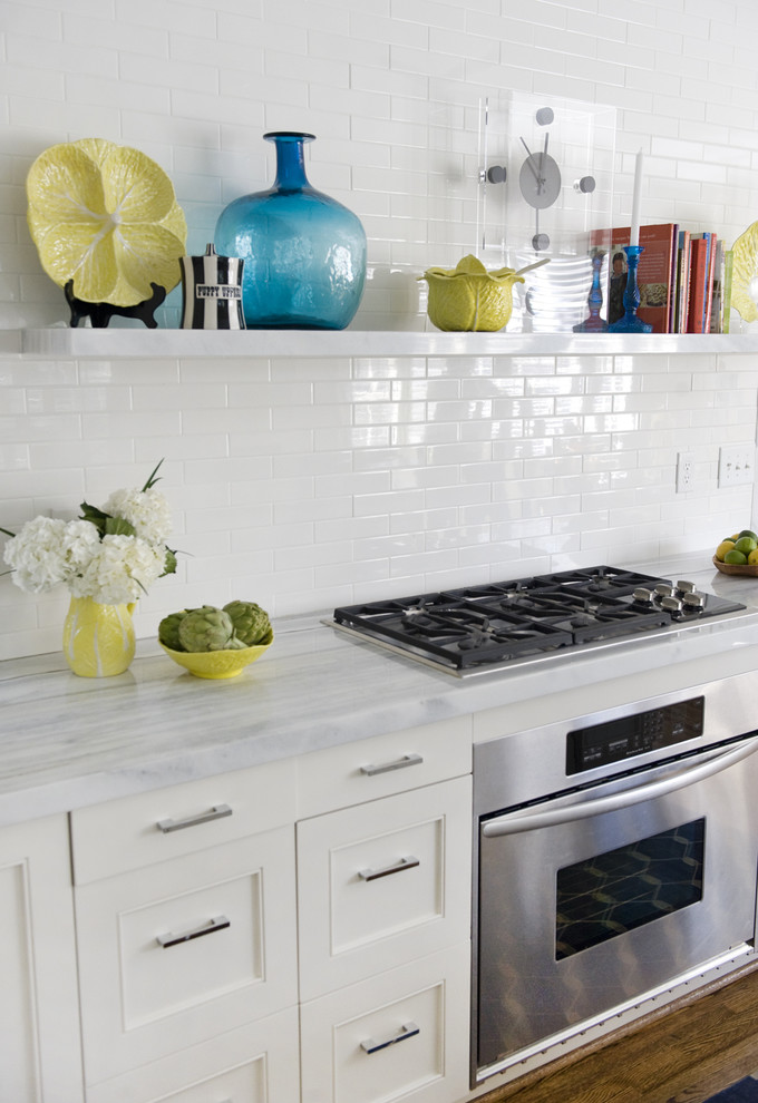 Kitchen - contemporary kitchen idea in Charlotte with marble countertops, recessed-panel cabinets, white cabinets, white backsplash and stainless steel appliances