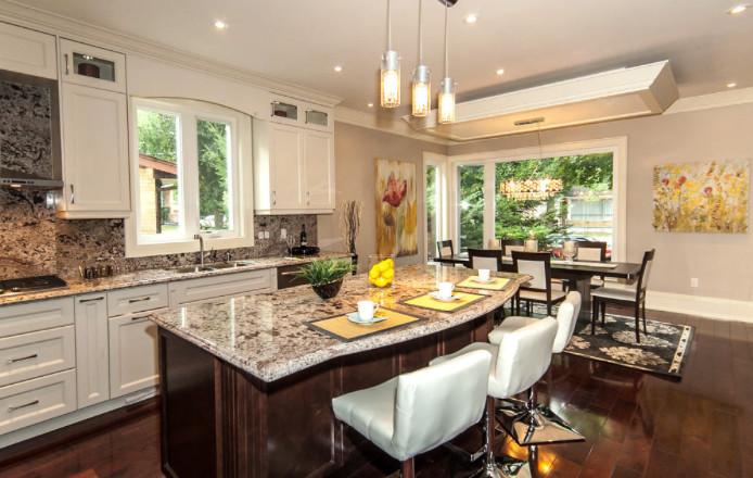 Eat-in kitchen - large contemporary l-shaped dark wood floor and brown floor eat-in kitchen idea in Toronto with an undermount sink, shaker cabinets, white cabinets, granite countertops, stainless steel appliances, an island, multicolored backsplash and stone slab backsplash