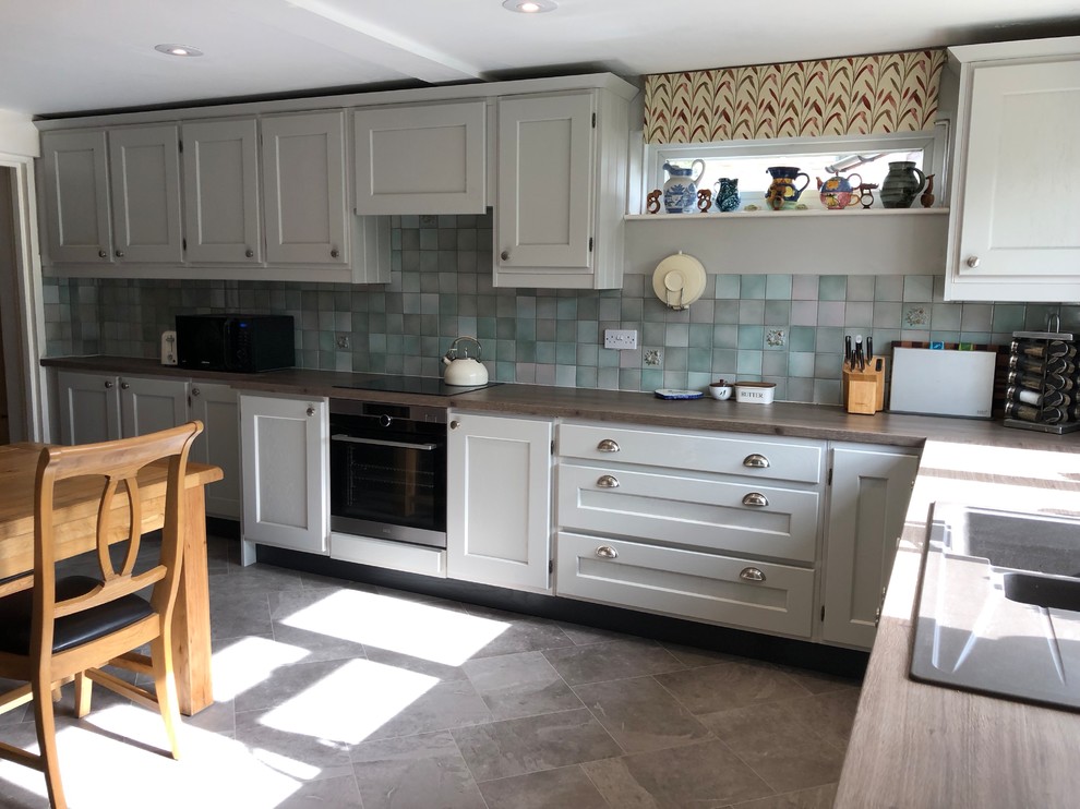 Inspiration for a farmhouse kitchen in Oxfordshire with a built-in sink, shaker cabinets, grey cabinets, laminate countertops, vinyl flooring, grey floors and brown worktops.
