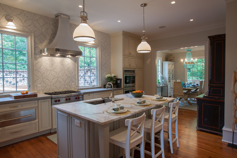 Example of a classic kitchen design in Atlanta with raised-panel cabinets, mosaic tile backsplash, stainless steel appliances, an undermount sink, beige cabinets, multicolored backsplash and marble countertops