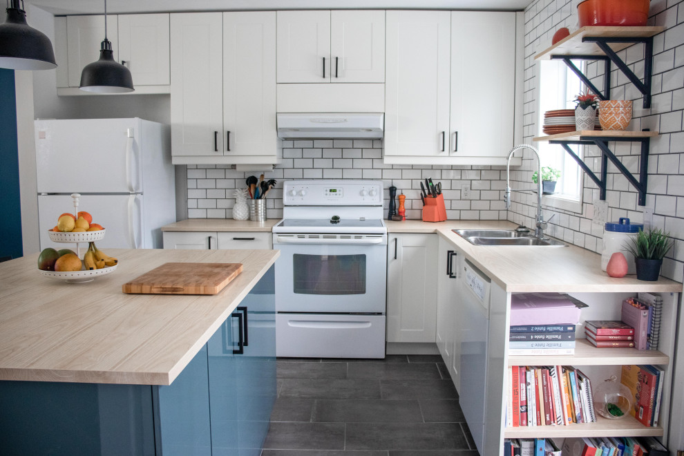 Eat-in kitchen - mid-sized cottage l-shaped porcelain tile and gray floor eat-in kitchen idea in Montreal with a double-bowl sink, shaker cabinets, white cabinets, laminate countertops, white backsplash, subway tile backsplash, white appliances, an island and beige countertops