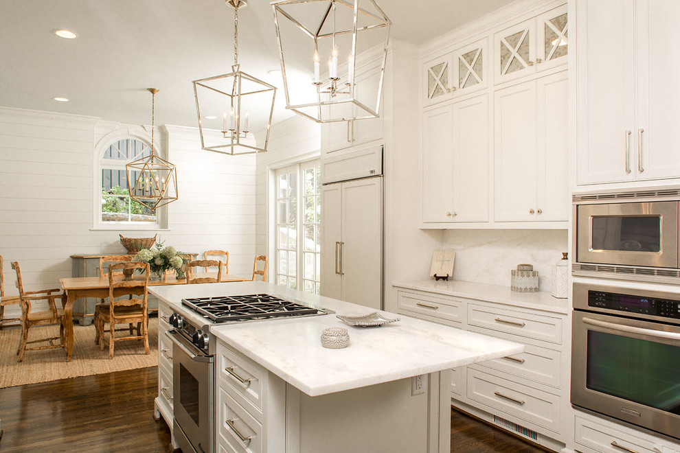 Transitional galley medium tone wood floor eat-in kitchen photo in Atlanta with beaded inset cabinets, white cabinets, white backsplash, an island and stainless steel appliances