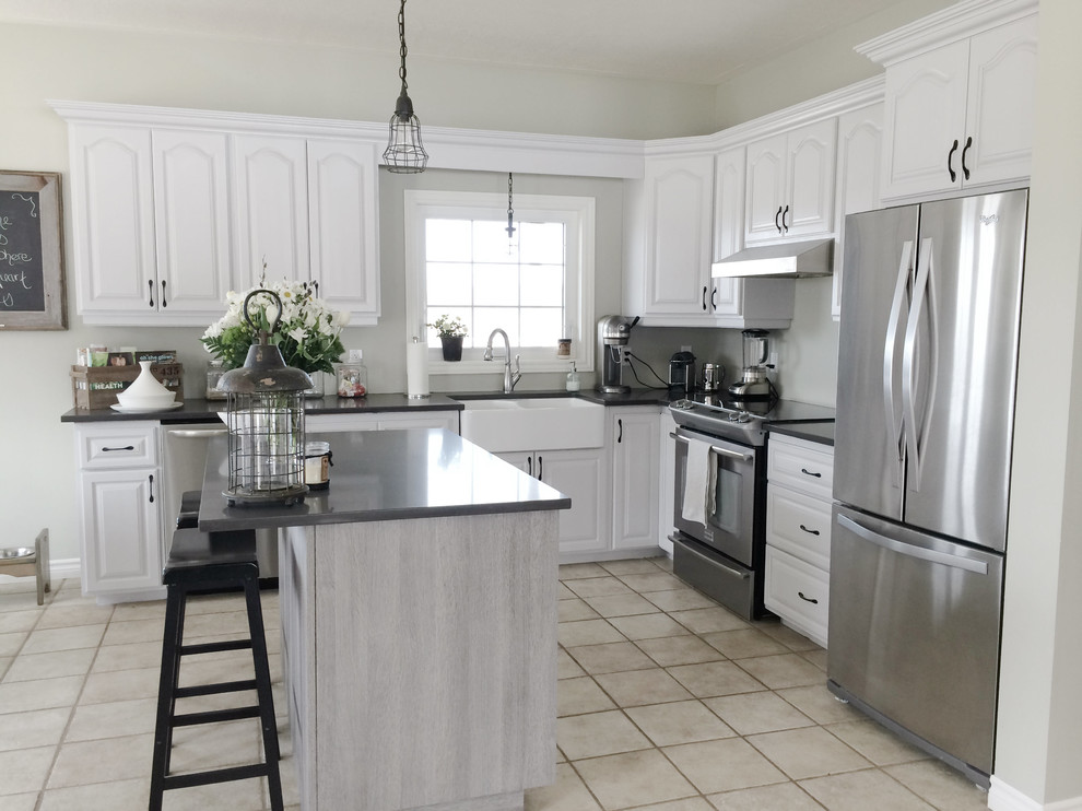 Large transitional l-shaped porcelain tile open concept kitchen photo in Toronto with a farmhouse sink, white cabinets, gray backsplash, stainless steel appliances, an island, raised-panel cabinets and quartz countertops