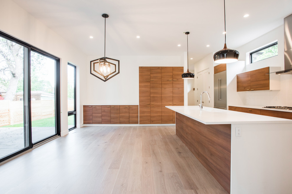 Example of a mid-sized minimalist l-shaped light wood floor and gray floor kitchen pantry design in Denver with a single-bowl sink, flat-panel cabinets, medium tone wood cabinets, quartz countertops, white backsplash, ceramic backsplash, stainless steel appliances and an island