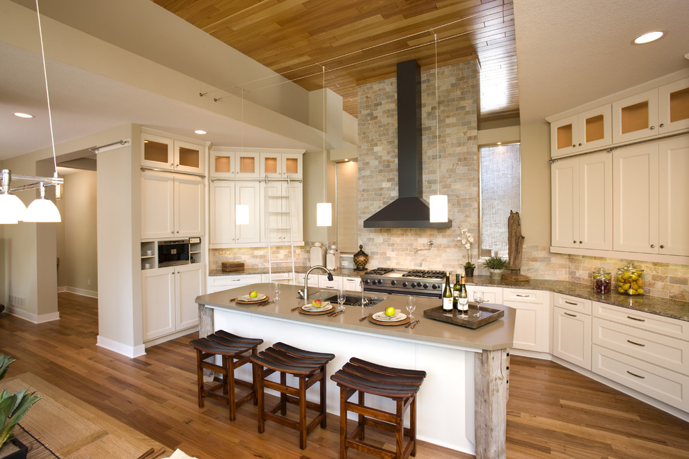 Example of a classic open concept kitchen design in Minneapolis with shaker cabinets, white cabinets, beige backsplash, stainless steel appliances and slate backsplash