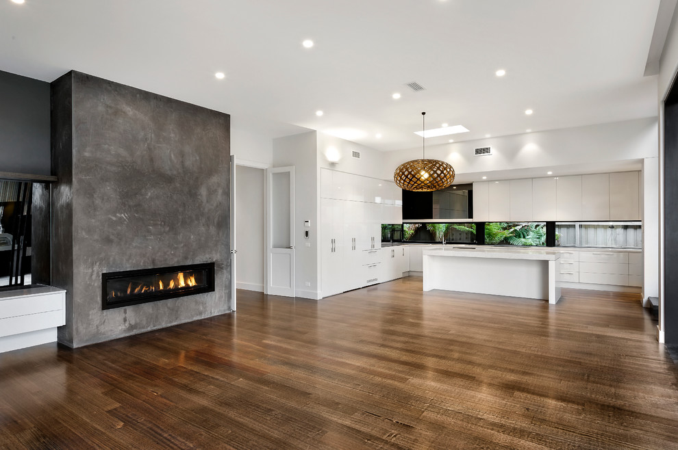 Inspiration for a contemporary kitchen in Melbourne with white cabinets, mirror splashback, stainless steel appliances, dark hardwood flooring and an island.