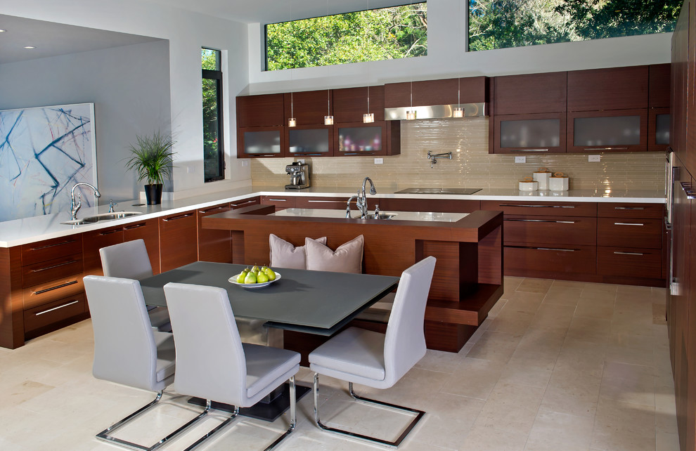Eat-in kitchen - large contemporary u-shaped travertine floor eat-in kitchen idea in Orlando with a drop-in sink, flat-panel cabinets, medium tone wood cabinets, beige backsplash, stainless steel appliances, an island, quartz countertops and glass tile backsplash