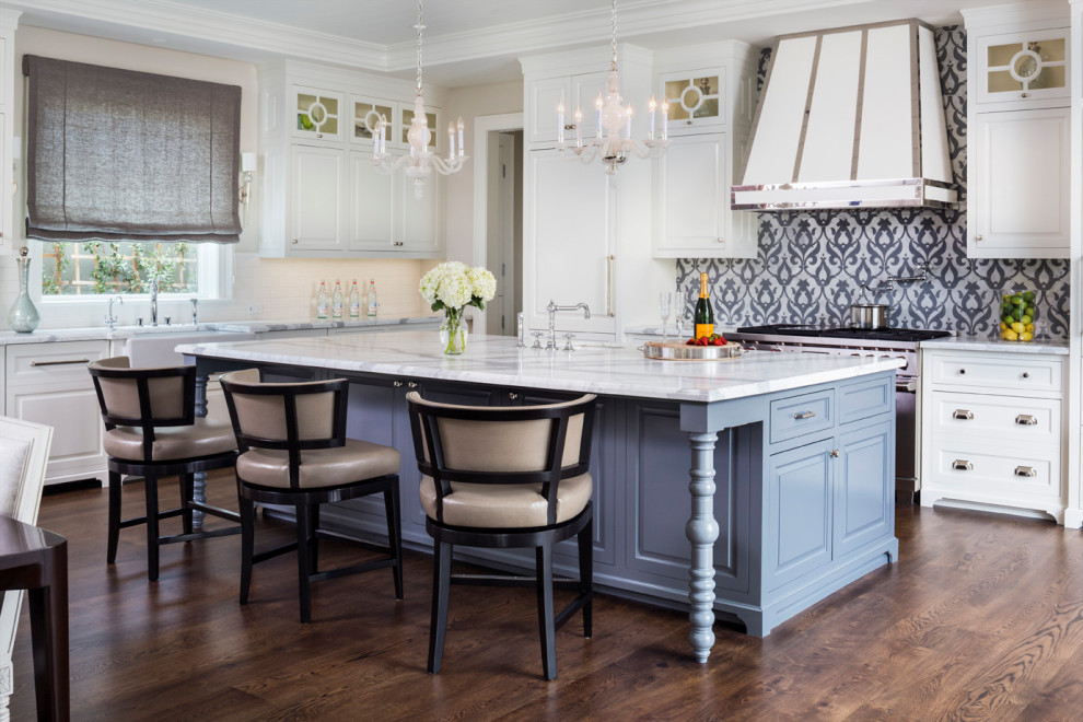 Inspiration for a timeless l-shaped dark wood floor and brown floor kitchen remodel in Los Angeles with a farmhouse sink, shaker cabinets, white cabinets, multicolored backsplash, stainless steel appliances, an island and white countertops