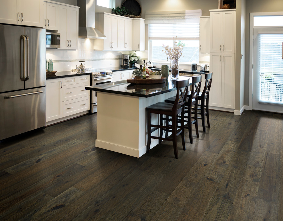 Trendy medium tone wood floor kitchen photo in Los Angeles with stainless steel appliances and an island