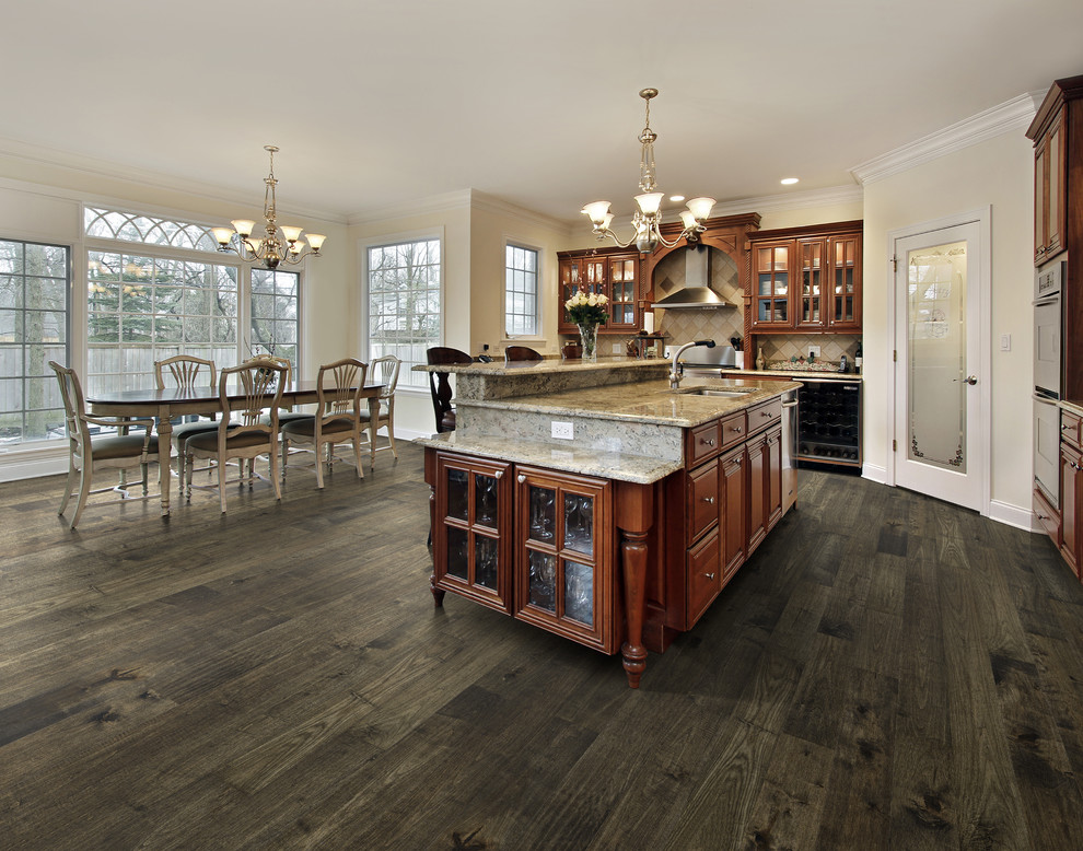 Example of a classic medium tone wood floor eat-in kitchen design in Los Angeles with stainless steel appliances and an island