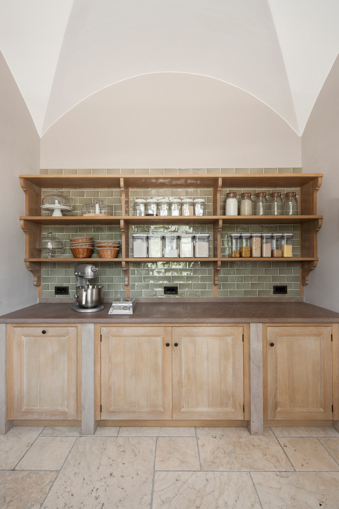 Inspiration for a medium sized traditional galley kitchen pantry in London with recessed-panel cabinets, distressed cabinets, green splashback, porcelain splashback, limestone flooring and no island.