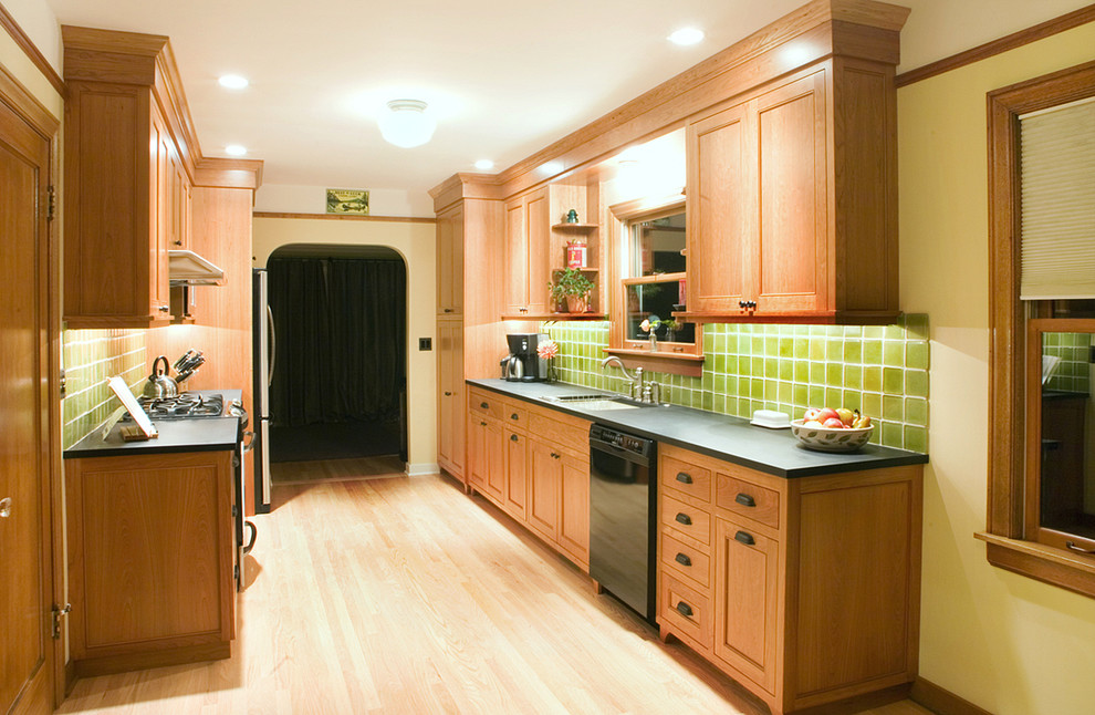 Small arts and crafts galley light wood floor kitchen photo in Seattle with an undermount sink, medium tone wood cabinets, black appliances and no island