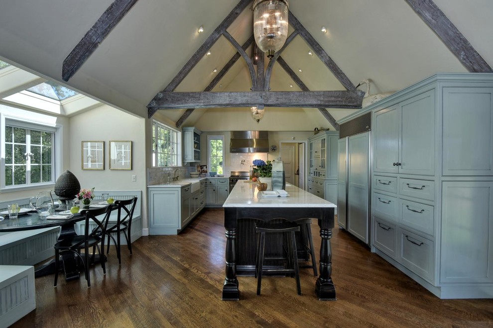 Inspiration for a traditional kitchen in San Francisco with a belfast sink, recessed-panel cabinets, blue cabinets, stainless steel appliances, dark hardwood flooring and an island.