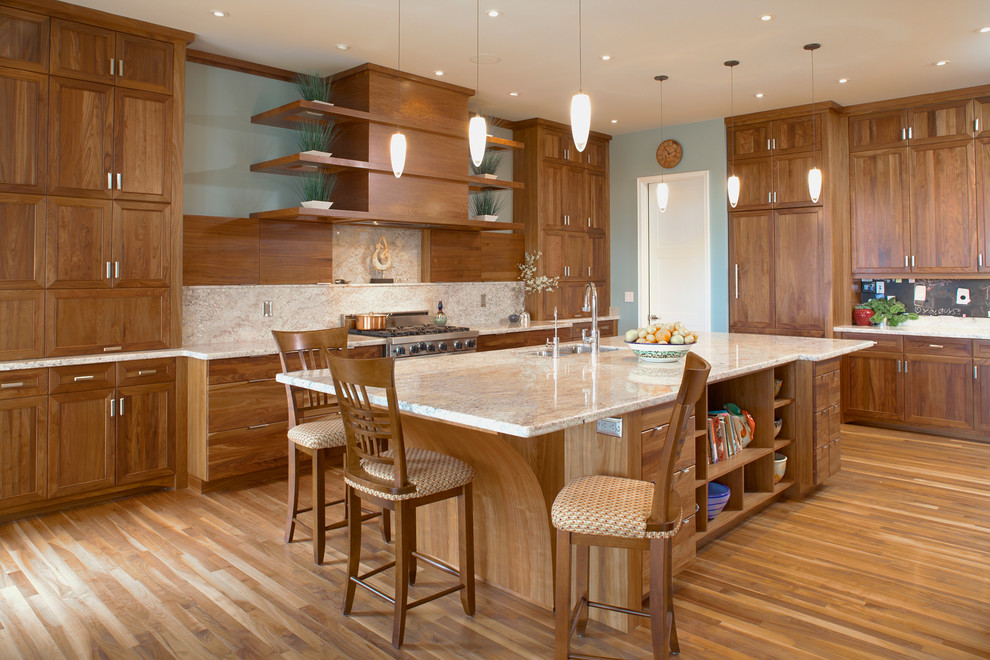 Photo of a contemporary kitchen in Calgary with recessed-panel cabinets, medium wood cabinets and stainless steel appliances.