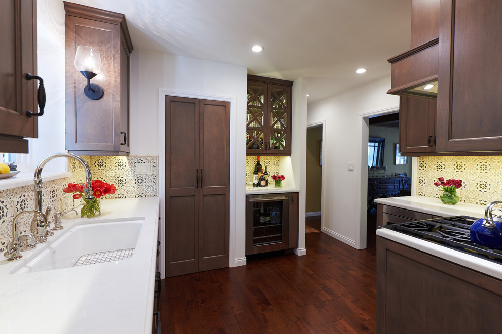 Foto di una grande cucina a L classica con elettrodomestici colorati, pavimento in legno verniciato e pavimento marrone