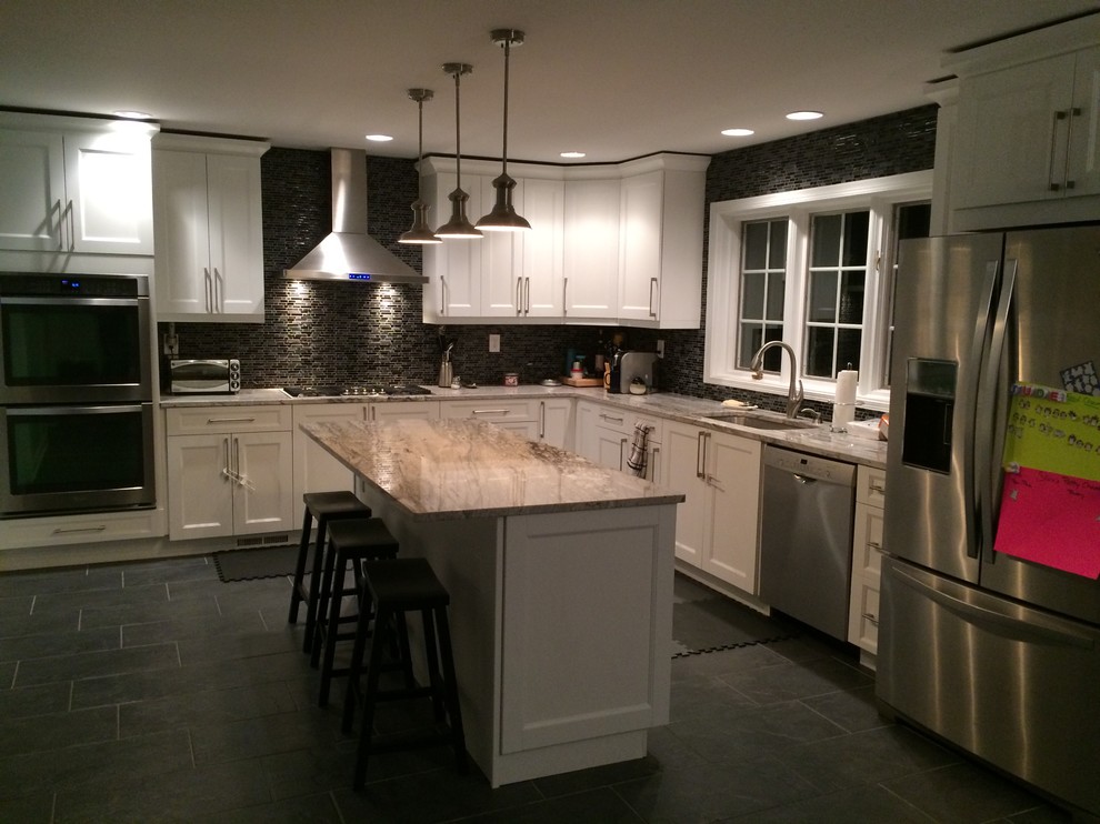 Inspiration for a large contemporary l-shaped porcelain tile eat-in kitchen remodel in Philadelphia with an undermount sink, shaker cabinets, white cabinets, granite countertops, black backsplash, mosaic tile backsplash, stainless steel appliances and an island