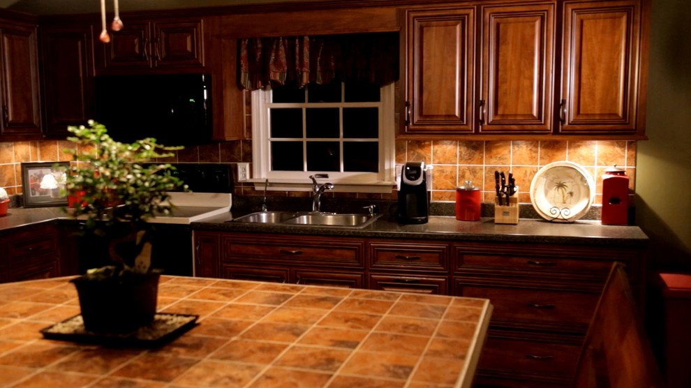 Inspiration for a timeless eat-in kitchen remodel in Philadelphia with raised-panel cabinets and dark wood cabinets