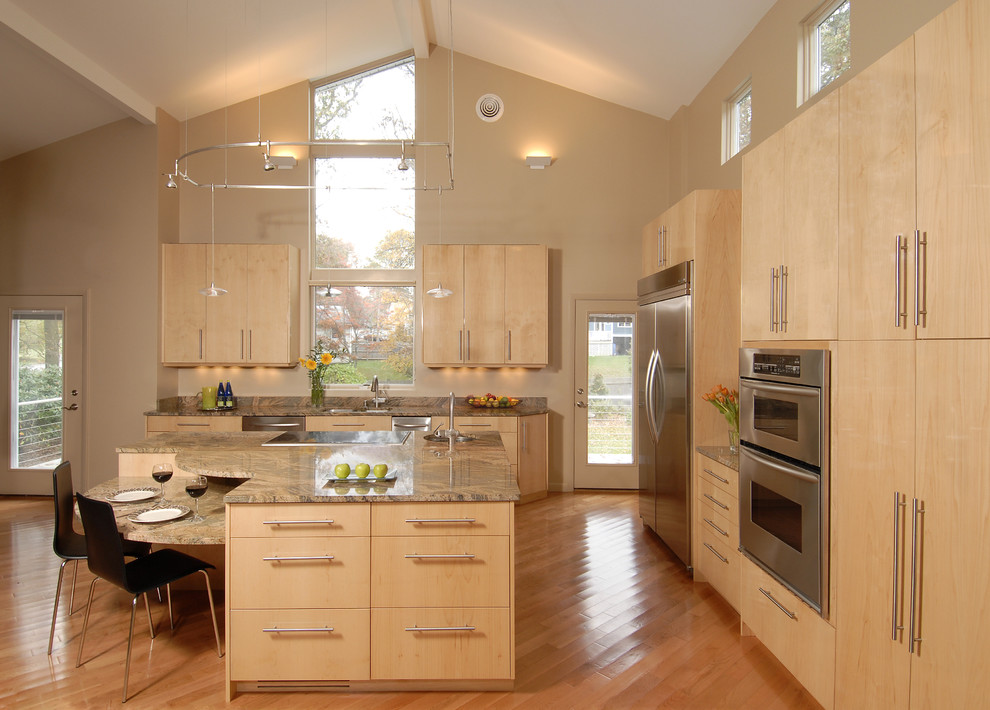 Example of a trendy kitchen design in Boston with stainless steel appliances, flat-panel cabinets and light wood cabinets