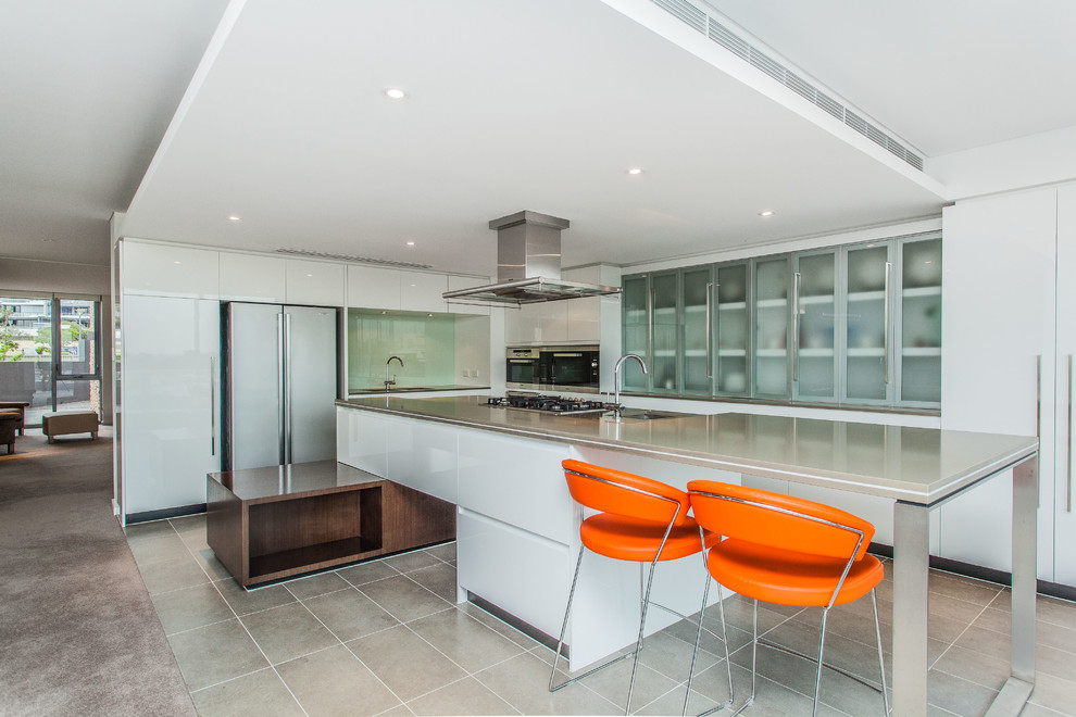 This is an example of a contemporary l-shaped kitchen in Perth with flat-panel cabinets, white cabinets, stainless steel appliances and an island.