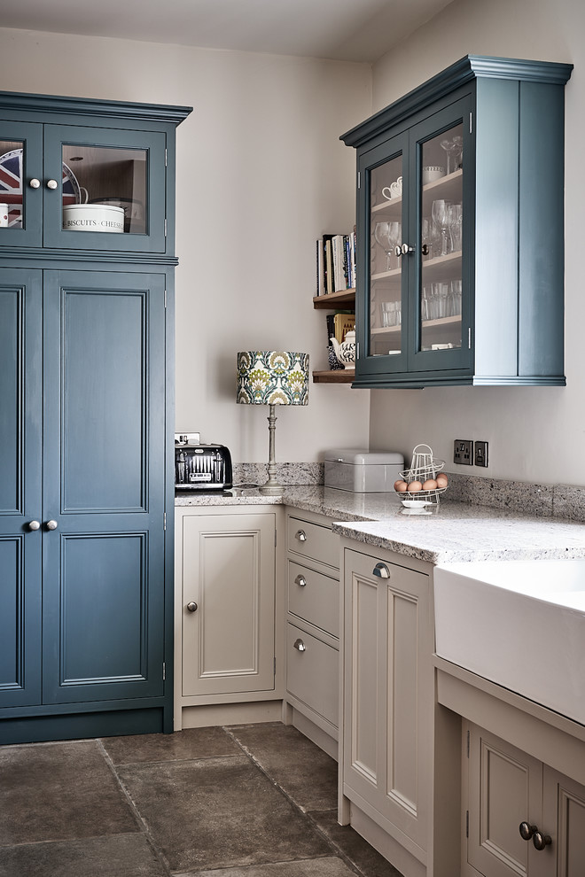 Example of a large classic ceramic tile and brown floor eat-in kitchen design in Other with a farmhouse sink, beaded inset cabinets, gray cabinets, granite countertops, blue backsplash, mosaic tile backsplash, colored appliances, no island and gray countertops