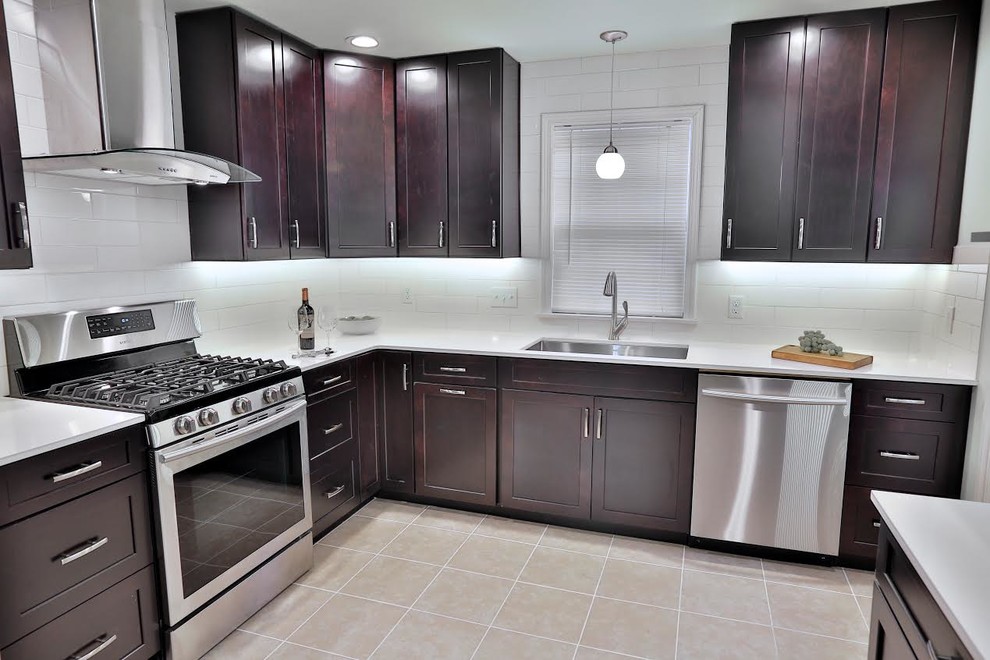 Eat-in kitchen - mid-sized contemporary u-shaped ceramic tile and beige floor eat-in kitchen idea in Other with an undermount sink, shaker cabinets, dark wood cabinets, quartzite countertops, white backsplash, subway tile backsplash, stainless steel appliances and no island