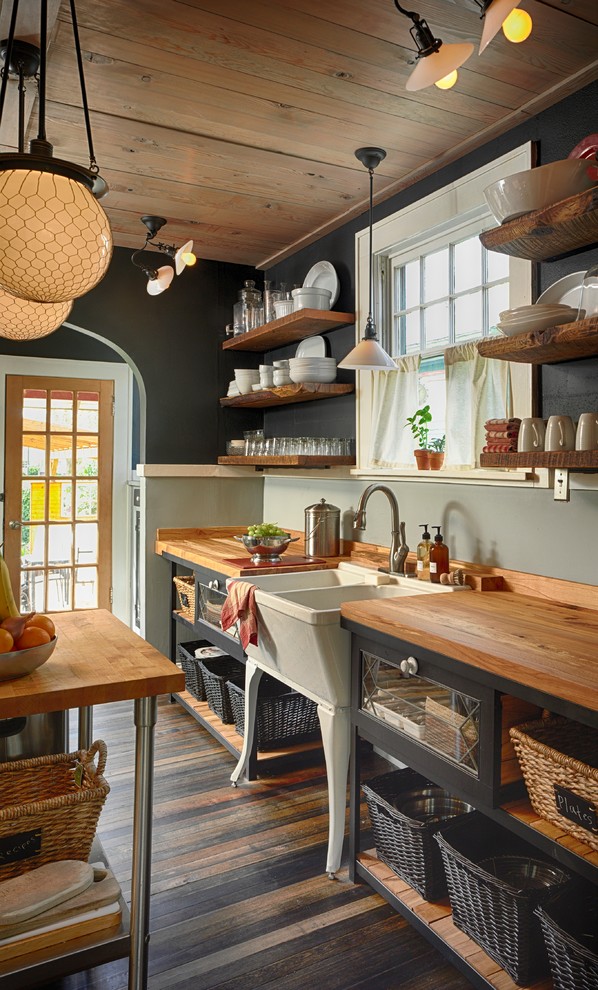 Example of a mountain style kitchen design in Portland with a farmhouse sink and open cabinets