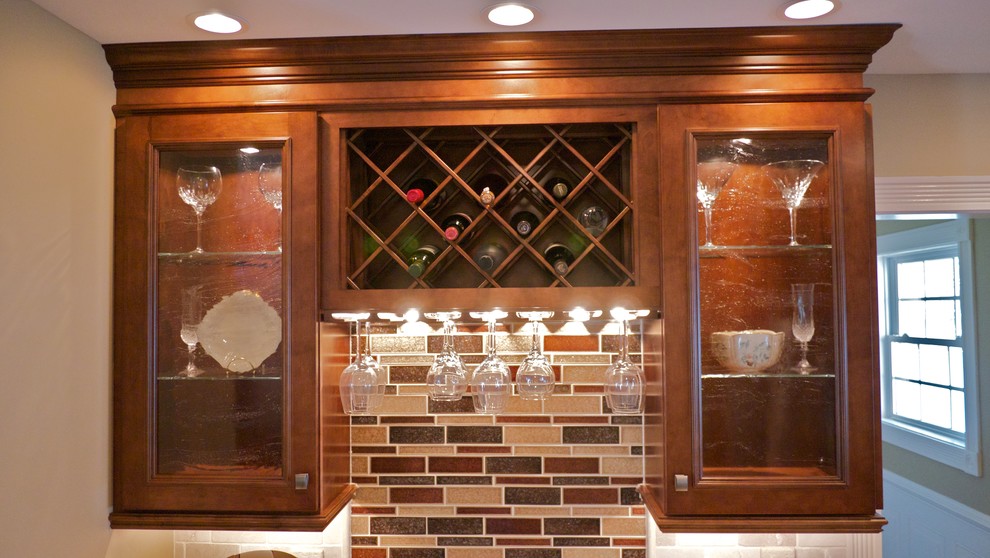 Foto di una cucina mediterranea di medie dimensioni con ante marroni, top in granito, paraspruzzi beige, elettrodomestici in acciaio inossidabile e pavimento in pietra calcarea