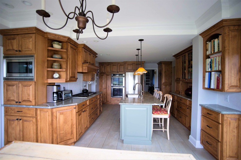 Example of a large farmhouse ceramic tile and beige floor kitchen design in New York with an undermount sink, glass-front cabinets, granite countertops, white backsplash, ceramic backsplash, stainless steel appliances, an island and green countertops