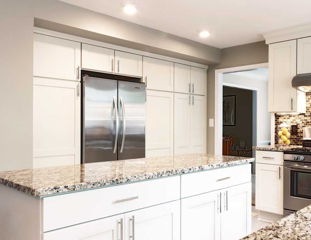 Large transitional u-shaped ceramic tile open concept kitchen photo in DC Metro with an undermount sink, shaker cabinets, white cabinets, quartz countertops, brown backsplash, subway tile backsplash, stainless steel appliances and an island