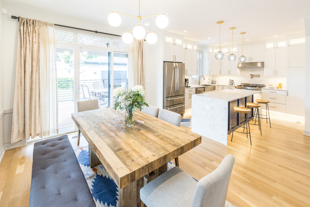 Eat-in kitchen - mid-sized transitional l-shaped light wood floor and beige floor eat-in kitchen idea in Chicago with a farmhouse sink, white cabinets, marble countertops, white backsplash, marble backsplash, stainless steel appliances, an island and white countertops