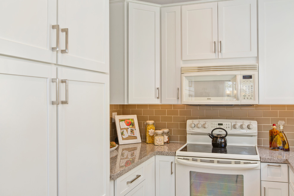 Small classic u-shaped enclosed kitchen in San Diego with shaker cabinets, white cabinets, engineered stone countertops, beige splashback, metro tiled splashback, white appliances, no island, a submerged sink and porcelain flooring.