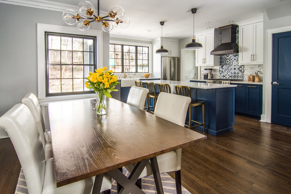 Example of a large transitional l-shaped dark wood floor and brown floor eat-in kitchen design in Newark with blue cabinets, marble countertops, white backsplash, stainless steel appliances, an island, white countertops, a single-bowl sink, mosaic tile backsplash and beaded inset cabinets