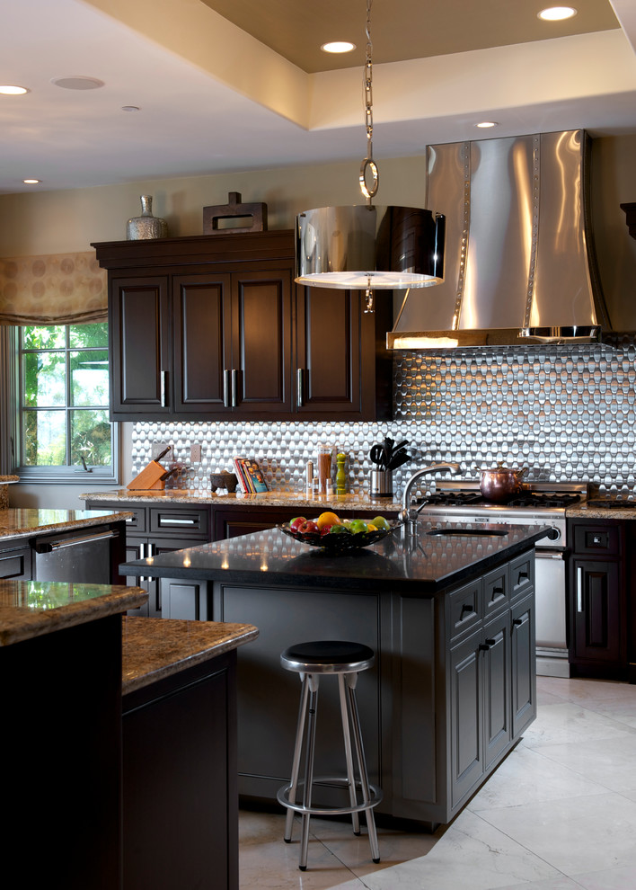 Exempel på ett stort klassiskt kök, med luckor med upphöjd panel, skåp i mörkt trä, stänkskydd med metallisk yta, rostfria vitvaror, en undermonterad diskho, granitbänkskiva, stänkskydd i metallkakel, kalkstensgolv, flera köksöar och beiget golv