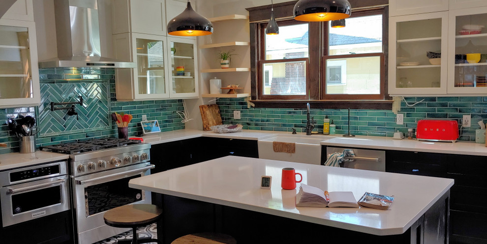 Inspiration for a medium sized classic u-shaped kitchen/diner in Boise with a belfast sink, shaker cabinets, quartz worktops, green splashback, ceramic splashback, stainless steel appliances, ceramic flooring, an island, white floors, white worktops, a vaulted ceiling and black cabinets.