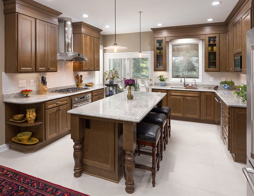 Kitchen - traditional kitchen idea in DC Metro with medium tone wood cabinets, granite countertops, gray backsplash and an island